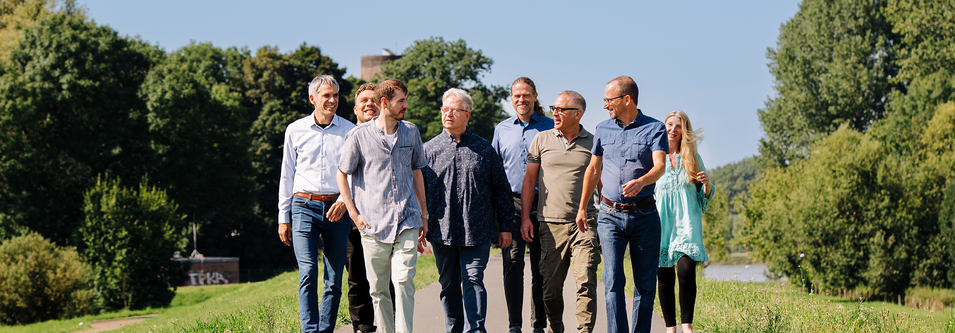 Das Team des IFL Instituts für Lärmschutz geht gemeinsam im Grünen und präsentiert sich in einer entspannten, natürlichen Atmosphäre.